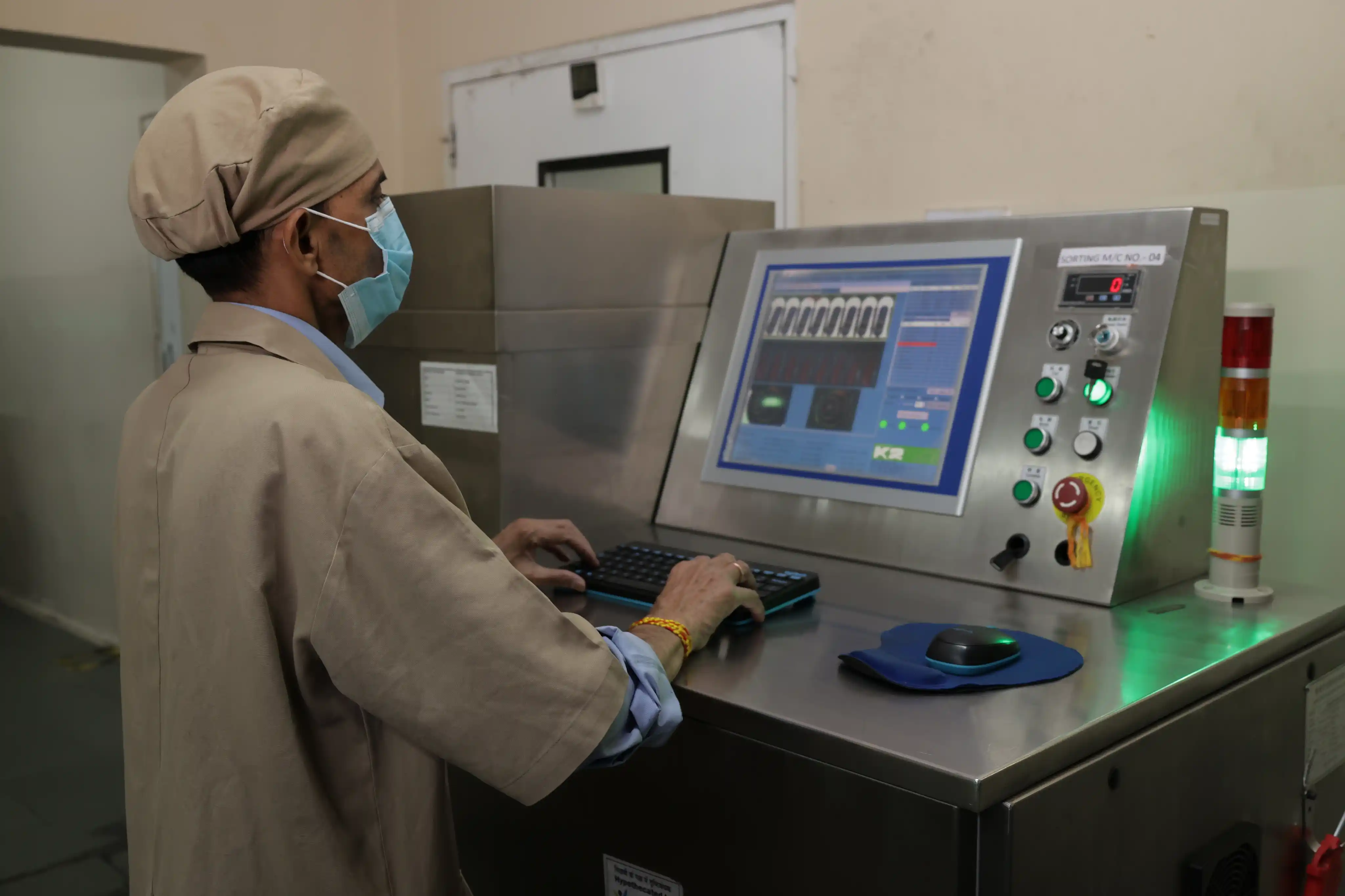 Operators running the automated capsule production line in a cleanroom